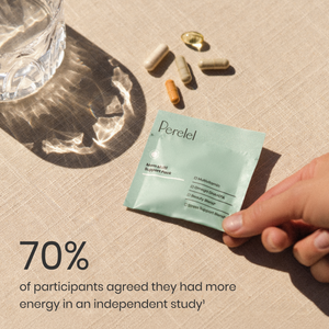 Perelel supplement pouch held by a hand with a glass of water and pills on a beige surface.