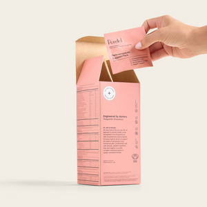 A hand lifts a daily sachet from an open box of Perelel Perimenopause Support Pack.