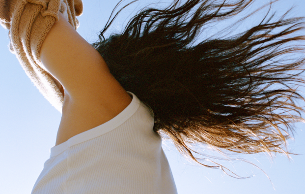 women with hands up outside